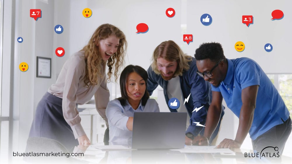 Team members laughing while reading a LinkedIn group page’s discussion